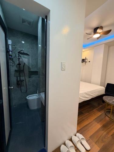 a bathroom with a shower and a bedroom with a bed at Manatad Transient Deluxe Room 2 in Surigao