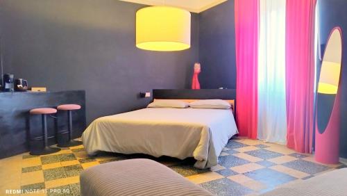 a bedroom with a bed with pink and purple curtains at Matilde Rooms in La Spezia