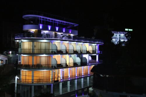 a building with a lit up facade at night at Sky View Grand in Kandy