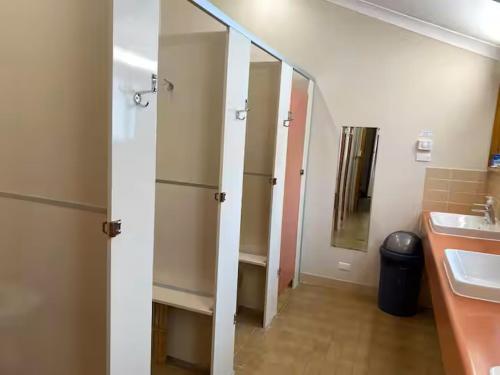 a bathroom with a sink and a mirror at Illabunda Ski Lodge in Perisher Valley