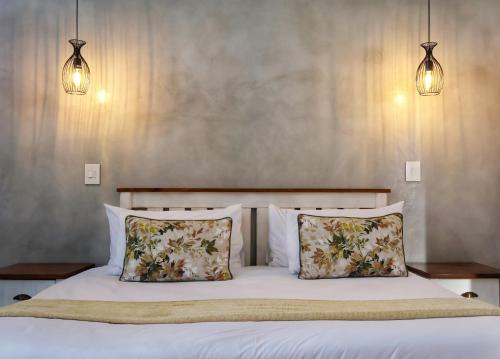 a bedroom with a bed with two pillows at Symponia Guesthouse in Khanzi