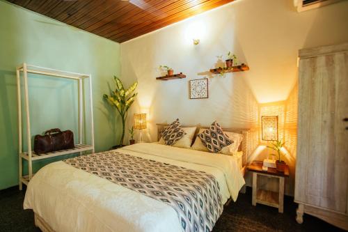 a bedroom with a large bed and two lights on the wall at Drop Inn Hostels in Colombo