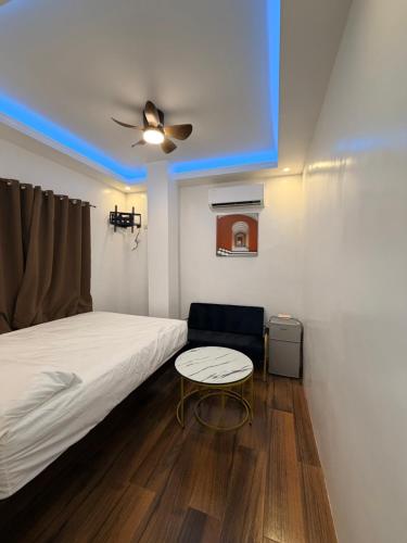 a small bedroom with a bed and a table at Manatad Transient Deluxe 3 in Surigao