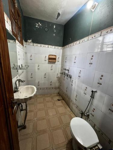 a dirty bathroom with a toilet and a sink at Home stays subash nagar in Jammu