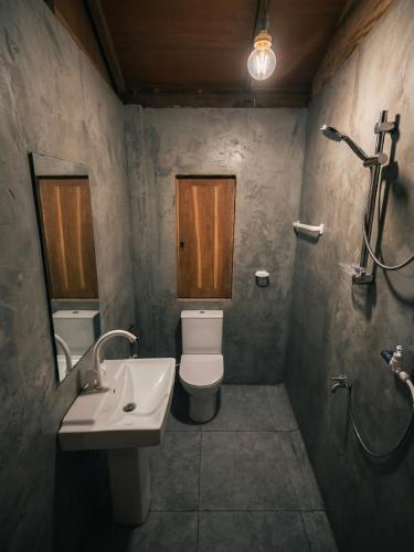 a bathroom with a toilet and a sink at Vercour Tree House Cabana Sigiriya in Sigiriya