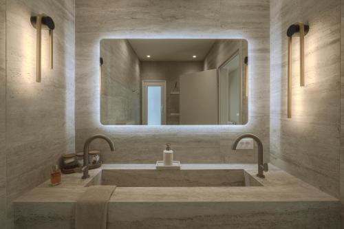 a bathroom with a large sink and a mirror at Akari - Luxury Apartment in Preveza