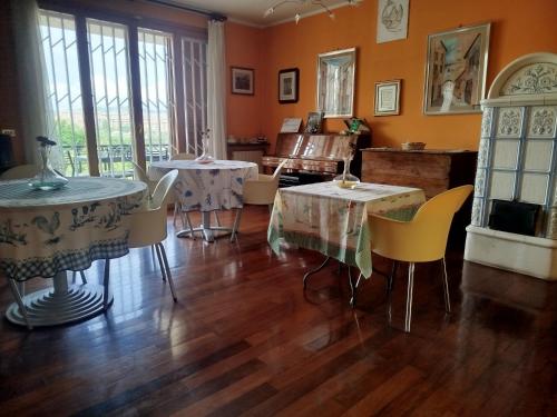 a room with two tables and chairs and a piano at B&B Signora Minù in Perugia