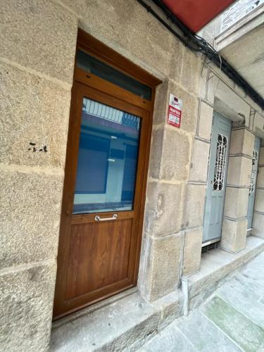 a wooden door on the side of a building at Estudio bajo la escalera in Redondela