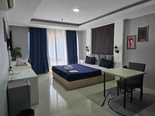 a bedroom with a bed and a table and a desk at Kay hotel in Angeles