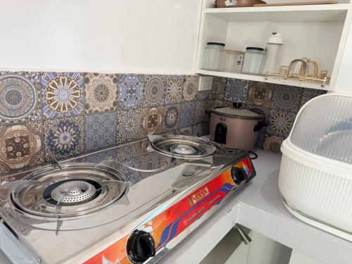 a kitchen with a stove and a counter top at Manatad Transient Family 3 in Surigao