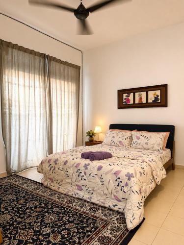 a bedroom with a bed and a window at Eryna Homestay in Nibung Tebal