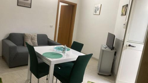 a living room with a table and chairs and a couch at Casa di Claudio in Arpaia