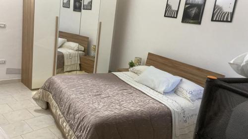 a bedroom with a bed and a large mirror at Casa di Claudio in Arpaia