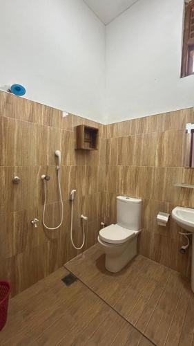 a bathroom with a toilet and a sink at Yellow bay inn in Arugam Bay