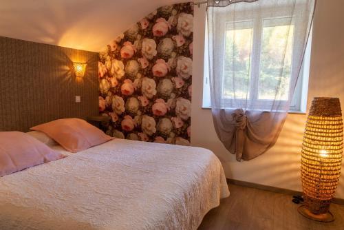 a bedroom with a bed and a window at Gîte de marthe in Sainte-Colombe-de-Peyre