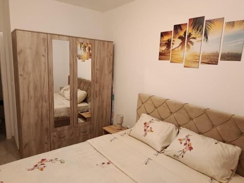 a bedroom with a bed and a large mirror at Top Spa apartman in Banja Koviljača