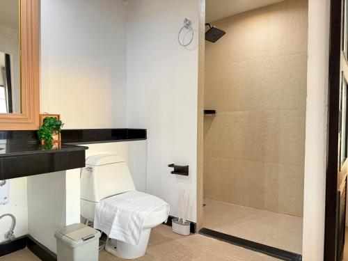 a bathroom with a toilet and a shower at Mr Oh in Phuket Karon in Ka Rorn