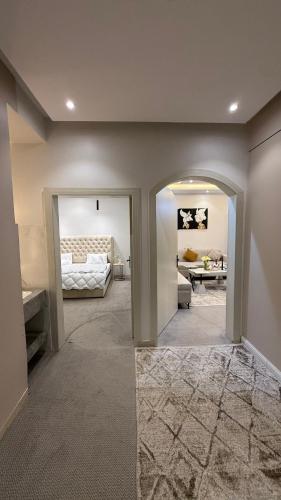 a room with a bedroom with a bed and a mirror at شقق مرفا in Hail