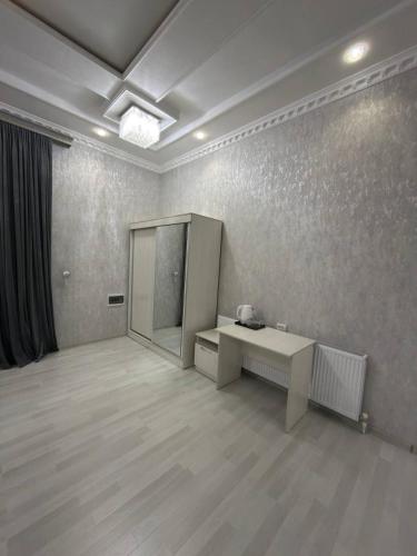 an empty room with a desk and a mirror at Global Star Hotel in Samarkand