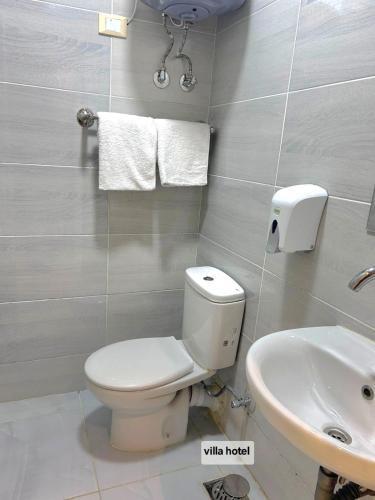 a bathroom with a white toilet and a sink at new Villa117 in Cairo