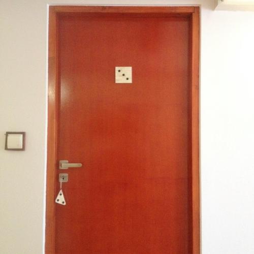 a wooden door with a clock on it at BaletyuKatany in Białka Tatrzanska