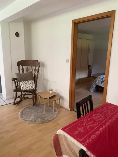 a room with a chair and a table and a mirror at Côté Jardin in Bourgheim