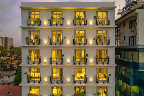 a facade of a building with yellow lights at Minimalist Panjim in Panaji