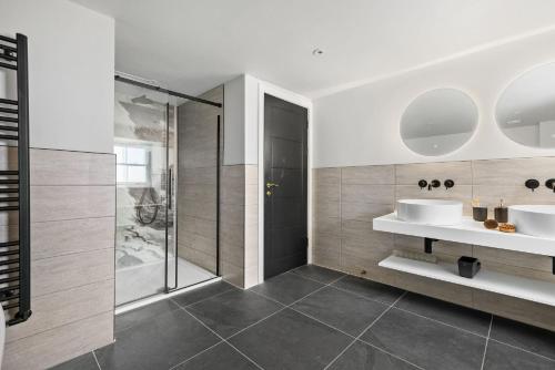 a bathroom with two sinks and a shower at Pilgrim Suite - Sea View - Free Wi-Fi in Brixham