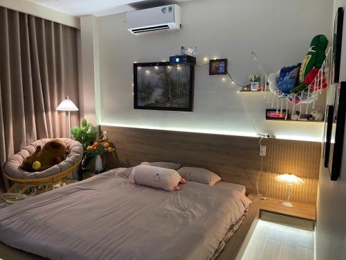 a bedroom with a bed with a stuffed animal on it at AN BÌNH Home in Hai Phong