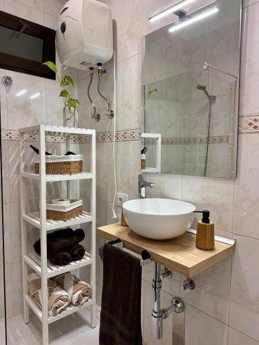 a bathroom with a white sink and a mirror at Hostjimeno Invierno in La Garita