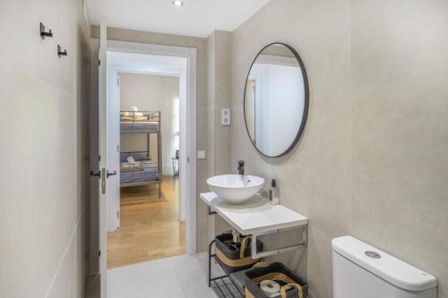 a bathroom with a sink and a mirror at Myholidayshome in Palamós
