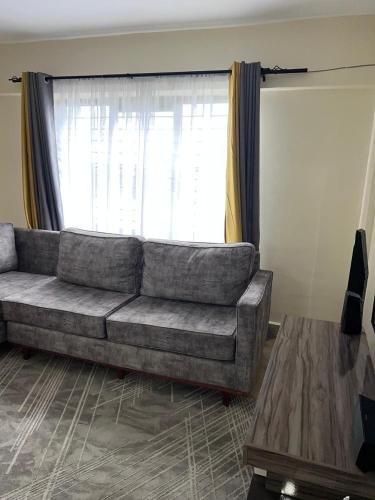 a living room with a couch in front of a window at Ample Safari Tours in Mombasa
