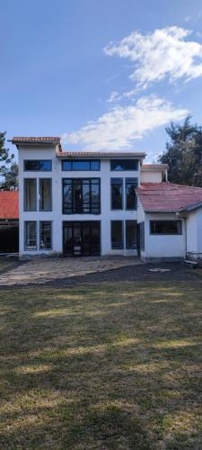 a large white building with a large yard at Ample Safari Tours in Mombasa