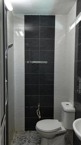 a small bathroom with a toilet and a sink at Mutiara Chalet in Malacca