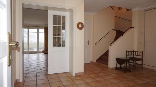 a hallway with a staircase in a house at Gut Settin am See - Ferienhäuser in Settin