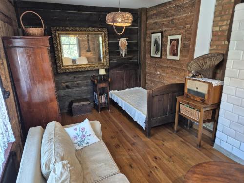 a living room with a couch and a mirror at Dom Dziadka in Janów Podlaski