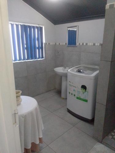 a bathroom with a sink and a washing machine at Columbae Guesthouse in Parys