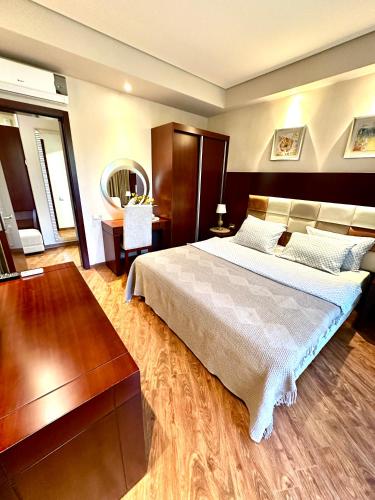 a bedroom with a large bed and a mirror at Beach Dreamland Oasis in Chakvi