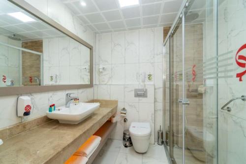 a bathroom with a sink and a toilet and a shower at Grand Şeker Hotel in Side