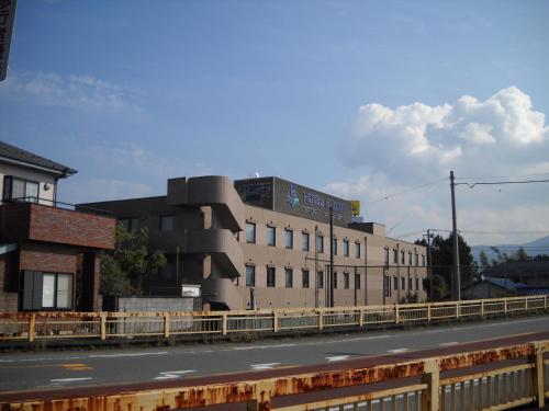 a building sitting on the side of a road at Hotel Kunimi Gotenba in Gotemba