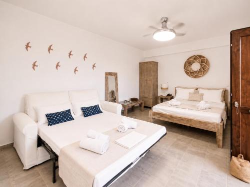 a living room with two beds and a couch at Marilia ViIlage Spathi Kea "Studio The Goat" in Spathi 
