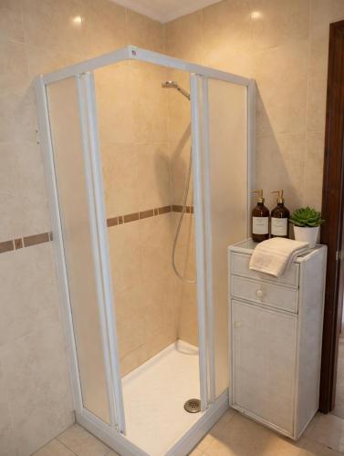 a shower with a glass door in a bathroom at Piso Almería playa in Almería
