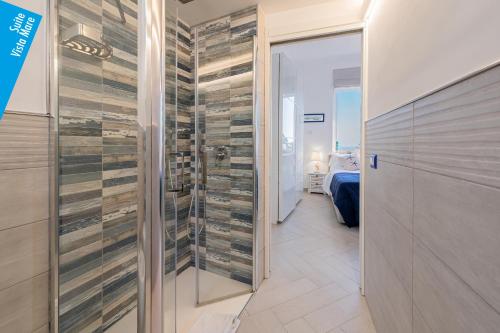 a walk in shower with a glass door in a room at Casa Leucosia Suites in Capri