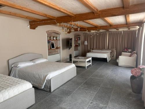 a bedroom with two beds and a living room at Villa Simona in Voghera