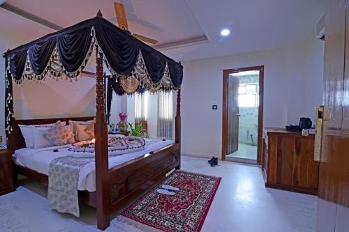 a bedroom with a canopy bed in a room at Lilypool - The Heritage Jalmahal in Jaipur