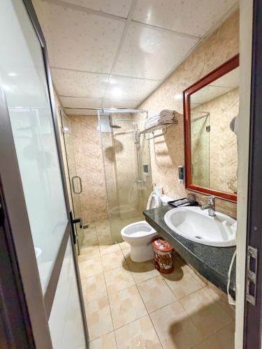 a bathroom with a sink and a toilet at Liberty Sapa Hotel in Sapa