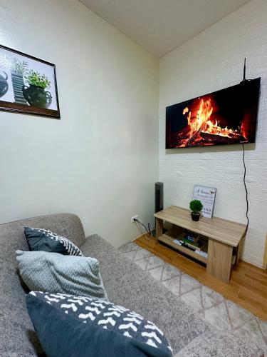 a living room with a couch and a fireplace at Te Haven in Davao City