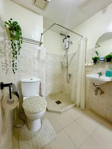 a bathroom with a toilet and a sink at Te Haven in Davao City
