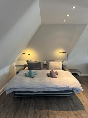 a bedroom with a large bed with two pillows at Sylt-Traum Kampen in Kampen