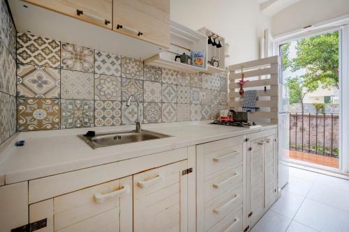 a kitchen with a sink and a large window at Garibaldi 54 in Bari